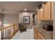 Second floor hallway area with built in cabinets, a chair and railing at 10524 Serengeti Dr, Lone Tree, CO 80124