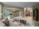 A comfortable living room transitions to the dining area at 10524 Serengeti Dr, Lone Tree, CO 80124