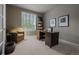 Comfortable home office with natural light, a dark wood desk and neutral decor at 10524 Serengeti Dr, Lone Tree, CO 80124