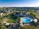 Community clubhouse aerial view featuring a swimming pool, fire pit, picnic area, and lush lawn at 27235 E Lakeview Pl, Aurora, CO 80016
