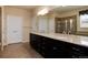 Elegant bathroom featuring dual sinks, granite countertops, and a glass shower at 27235 E Lakeview Pl, Aurora, CO 80016