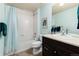 Well-lit bathroom featuring a shower-tub combo, modern sink, and neutral tile at 27235 E Lakeview Pl, Aurora, CO 80016