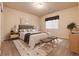 Cozy bedroom featuring soft gray walls, a padded headboard, and minimalist decor at 27235 E Lakeview Pl, Aurora, CO 80016