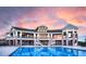 The clubhouse pool area boasts stunning architecture with a shimmering pool at sunset at 27235 E Lakeview Pl, Aurora, CO 80016