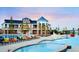 Community pool with a shallow splash area and colorful lounge chairs under a bright sky at 27235 E Lakeview Pl, Aurora, CO 80016