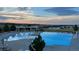 Inviting community pool with a serene atmosphere, loungers, and beautiful sunset views at 27235 E Lakeview Pl, Aurora, CO 80016
