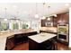 Spacious kitchen features granite countertops, stainless steel appliances, and a center island with seating, perfect for culinary enthusiasts at 27235 E Lakeview Pl, Aurora, CO 80016