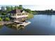 Picturesque lake house with boat dock and pedal boats, nestled along a calm lake at 27235 E Lakeview Pl, Aurora, CO 80016