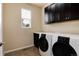 Well-equipped laundry room with modern washer and dryer, ample storage, and a convenient sink at 27235 E Lakeview Pl, Aurora, CO 80016