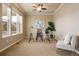 Well-lit home office with a modern glass desk, comfortable chair, and large windows for natural light at 27235 E Lakeview Pl, Aurora, CO 80016