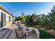 Inviting patio with stone fire pit, outdoor seating, and well-maintained landscaping at 27235 E Lakeview Pl, Aurora, CO 80016