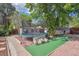 The backyard features a turfed area, a trampoline, and a bricked pathway that leads to the back of the property at 1817 S Perry Way, Denver, CO 80219