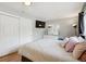 Bedroom featuring hardwood floors, neutral walls, and a large window with natural light at 1817 S Perry Way, Denver, CO 80219