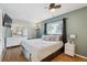 Comfortable bedroom featuring hardwood floors, a large window, and a neutral color scheme at 1817 S Perry Way, Denver, CO 80219