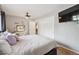 Comfortable bedroom with hardwood floors, a closet, and a stylish vanity area at 1817 S Perry Way, Denver, CO 80219