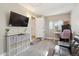 This is a bedroom with a large TV mounted on the wall, ample closet space, and an adjacent office area at 1817 S Perry Way, Denver, CO 80219