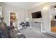Versatile room featuring comfortable seating, a mounted TV, and additional storage at 1817 S Perry Way, Denver, CO 80219
