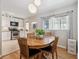 Dining room featuring hardwood floors, natural lighting, and a round wooden table with four chairs at 1817 S Perry Way, Denver, CO 80219