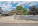 Charming single-story home featuring a welcoming entrance, white picket fence, and well-maintained landscaping at 1817 S Perry Way, Denver, CO 80219