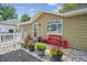 Charming single-story home with a cozy front porch and well-manicured garden featuring vibrant potted flowers at 1817 S Perry Way, Denver, CO 80219