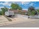 Quaint single-story home with a camper parked nearby, featuring a white picket fence and landscaped front yard at 1817 S Perry Way, Denver, CO 80219