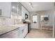 Well-lit kitchen showcasing stainless steel appliances, white cabinets, and a farmhouse sink at 1817 S Perry Way, Denver, CO 80219