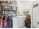 Functional laundry room with a washer, dryer, storage shelves, and organization for efficient household tasks at 1817 S Perry Way, Denver, CO 80219