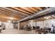 Unfinished basement with exposed beams, utility installations, and ample space for customization at 9571 Yucca Ct, Arvada, CO 80007