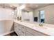 Modern bathroom featuring dual sinks, a spacious walk-in shower with white subway tile, and a well-lit vanity at 9571 Yucca Ct, Arvada, CO 80007