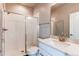 Bright bathroom featuring a modern glass shower enclosure, stylish vanity, and updated fixtures at 9571 Yucca Ct, Arvada, CO 80007
