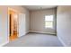 This bedroom offers a window, closet space, and neutral carpet at 9571 Yucca Ct, Arvada, CO 80007
