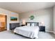Comfortable bedroom featuring a well-lit interior, with neutral tones, carpet, and nearby ensuite access at 9571 Yucca Ct, Arvada, CO 80007