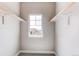 Walk-in closet featuring a well-lit window, simple organizational rods, and neutral walls at 9571 Yucca Ct, Arvada, CO 80007
