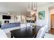 Elegant dining area with modern lighting, fireplace, and open concept flow into the living spaces at 9571 Yucca Ct, Arvada, CO 80007