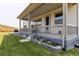 Charming home featuring a covered porch, manicured lawn, and beautiful landscaping at 9571 Yucca Ct, Arvada, CO 80007