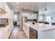Well-designed kitchen with stainless steel appliances, white cabinetry, and ample counter space at 9571 Yucca Ct, Arvada, CO 80007
