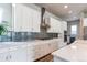 Modern kitchen featuring white cabinetry, stainless steel appliances, and stylish backsplash at 9571 Yucca Ct, Arvada, CO 80007