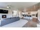 Inviting living space with fireplace flows into a modern kitchen with a center island and bar stool seating at 9571 Yucca Ct, Arvada, CO 80007