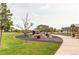 Community playground with rock climbing feature and shady trees at 9571 Yucca Ct, Arvada, CO 80007