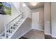 Bright foyer with a staircase featuring white railings, leading to upper level, and an art on the wall at 9571 Yucca Ct, Arvada, CO 80007