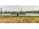 Community tennis court with benches, trash can, and fence at 9571 Yucca Ct, Arvada, CO 80007