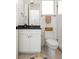Modern bathroom featuring a white vanity with a black countertop, a toilet, and a glass-enclosed shower at 2012 W 46Th Ave, Denver, CO 80211