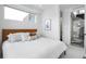 Bright bedroom features a bed with white bedding, a picture frame, and windows for plenty of light at 2012 W 46Th Ave, Denver, CO 80211