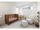 Bright Bedroom features a wooden crib, white rocking chair with ottoman, and a play tent at 2012 W 46Th Ave, Denver, CO 80211