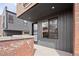Contemporary townhome exterior with a gray facade, brick accents, and visible street number at 2012 W 46Th Ave, Denver, CO 80211