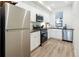 Modern kitchen featuring stainless steel appliances, white cabinetry, and sleek countertops at 2012 W 46Th Ave, Denver, CO 80211