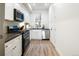 Bright kitchen with stainless steel appliances, white cabinets, and modern fixtures at 2012 W 46Th Ave, Denver, CO 80211