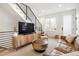 Bright living room with modern staircase, sleek furnishings, and abundant natural light at 2012 W 46Th Ave, Denver, CO 80211