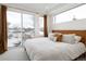 Sunlit bedroom with a sliding glass door to a balcony and neutral decor at 2012 W 46Th Ave, Denver, CO 80211