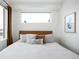 Calming bedroom with bright window, wood frame bed and neutral colored bedding at 2012 W 46Th Ave, Denver, CO 80211